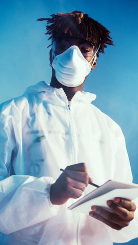 Man in mask and white coveralls